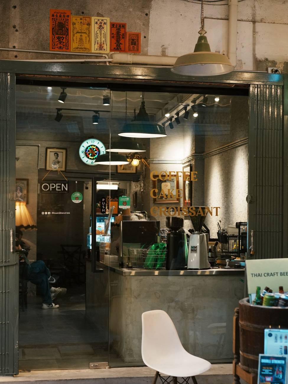 Demonstration photograph. A modern shop interior with a counter, pendant lights and a pale chair.
